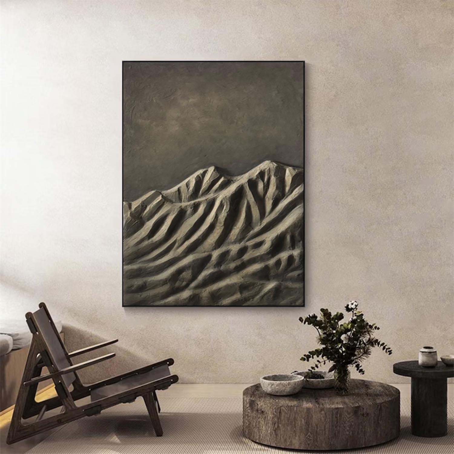 Modern interior with a mountain painting on the wall, wooden chair, and round coffee table.