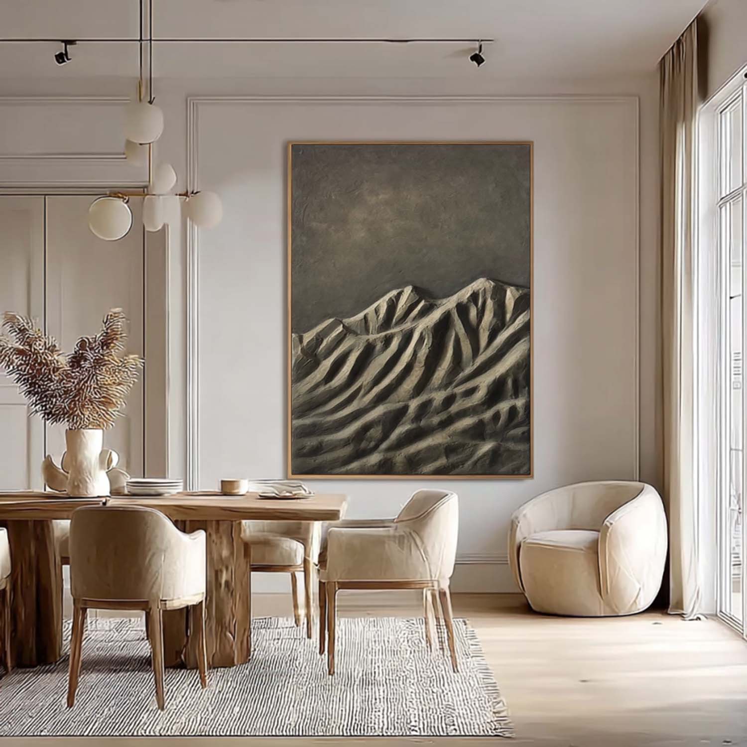 Modern dining room with wooden table, chairs, and a mountain painting on the wall.