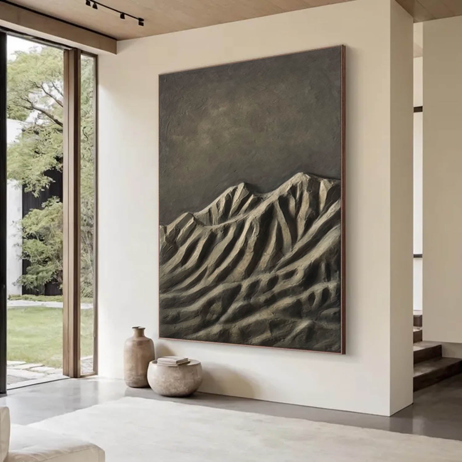 Large abstract mountain painting in a modern living room with large windows.