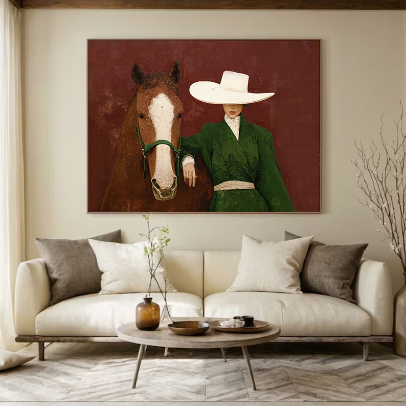 Living room with a painting of a person in a green outfit and white hat with a horse on the wall.